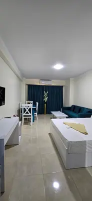 a living room with two beds and a blue couch at Tiba Golden Azure Coast Hurghada in Hurghada