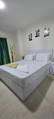 a large white bed in a white room at Tiba Golden Sapphire Hurghada in Hurghada