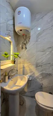 a bathroom with a white sink and a toilet at Tiba Golden Sapphire Hurghada in Hurghada