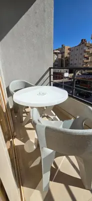 a white table and chairs on a balcony at Tiba Golden Sapphire Hurghada in Hurghada
