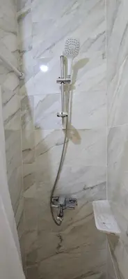 a shower with a shower head in a bathroom at Tiba Golden Sapphire Hurghada in Hurghada