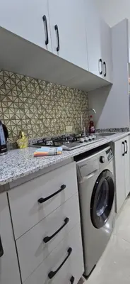 a kitchen with a washer and a washing machine at Tiba Golden Sapphire Hurghada in Hurghada