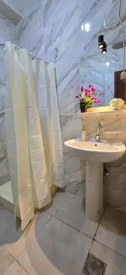 a bathroom with a white sink and a shower at Tiba Golden Aqua Vista Hurghada in Hurghada