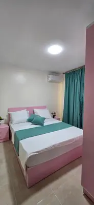 a bedroom with a large bed in a room at Tiba Golden Sunset Oasis Hurghada in Hurghada