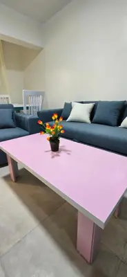 a pink coffee table with a vase of flowers on it at Tiba Golden Sunset Oasis Hurghada in Hurghada