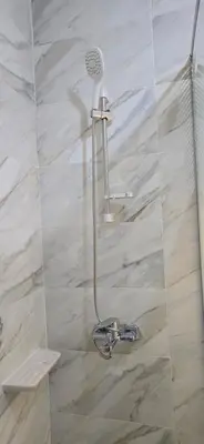 a shower with a shower head in a bathroom at Tiba Golden Beach View Hurghada in Hurghada
