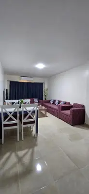 a living room with a couch and a table at Tiba Golden Beach View Hurghada in Hurghada