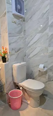 a bathroom with a white toilet in a room at Tiba Golden Beach View Hurghada in Hurghada