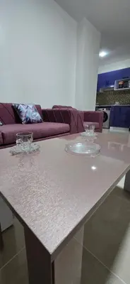 a white table in a living room with a couch at Tiba Golden Beach View Hurghada in Hurghada