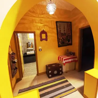 a room with a hallway with a table and a mirror at Villa Karmen in Luxor