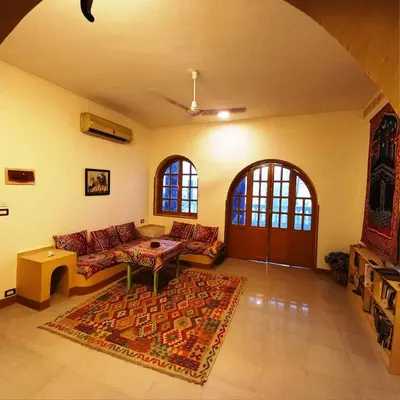 a living room with a couch and a rug at Villa Karmen in Luxor