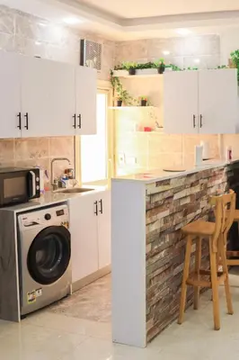 a kitchen with a washer and dryer at Golden Home Hurghada El Kauser in Hurghada