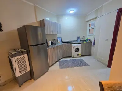 a kitchen with a stainless steel refrigerator and a dishwasher at شقة in Hurghada
