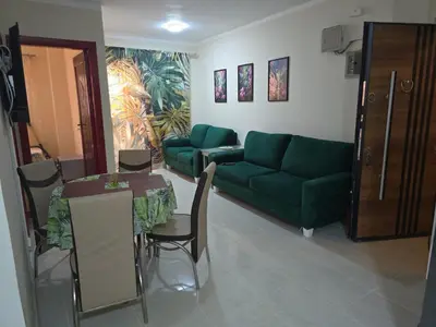 a living room with a green couch and a table at شقة in Hurghada