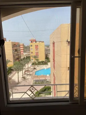 a view of a pool from a window at El Hambra compound in Hurghada