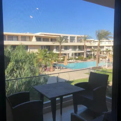 a balcony with a table and a view of a building at Cozy Studio in Hurghada