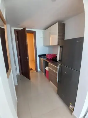 a kitchen with a refrigerator and a counter top at Cozy Studio in Hurghada