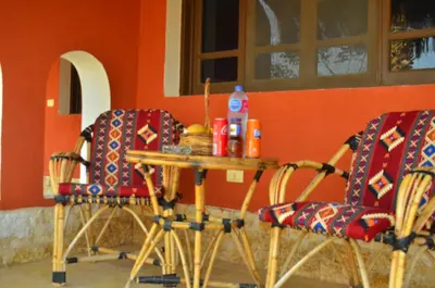 a table and chairs in a room with an orange wall at Sun Beach Hotel ABO SOMA in Hurghada