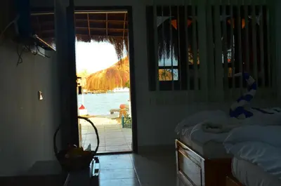 a bedroom with a door open to a view of the water at Sun Beach Hotel ABO SOMA in Hurghada