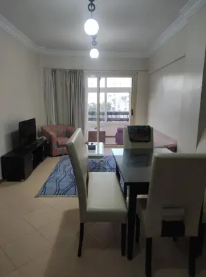 a living room with a table and chairs and a couch at Hurghada in Hurghada
