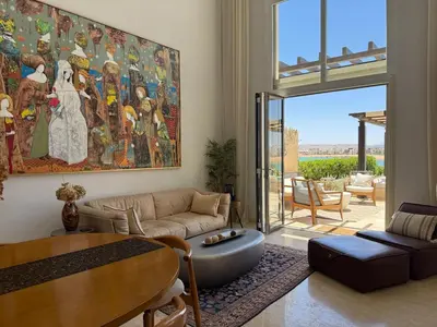 a living room with a large painting on the wall at Gouna's Best Villa in Hurghada