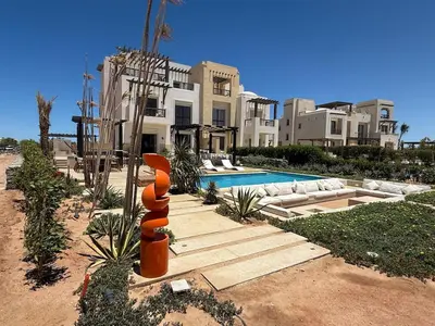 a large house with a swimming pool in front of it at Gouna's Best Villa in Hurghada