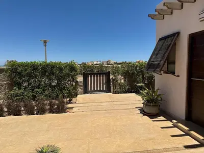 a walkway leading to a building with a gate at Gouna's Best Villa in Hurghada