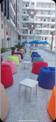 a group of tables with colored pillows in a building at TiBa Golden Resort in Hurghada