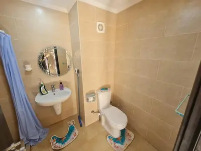 a small bathroom with a toilet and a sink at AlDau Heights Modern Studio with Terrace, Mountain & City View in Hurghada
