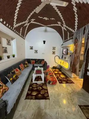 a living room with a couch and a table at Salem & Renča Guest House in Luxor