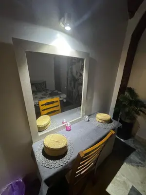 a table with two hats on it with a mirror at Salem & Renča Guest House in Luxor