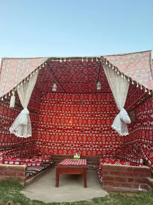 a large auditorium with red seats and a table at Salem & Renča Guest House in Luxor