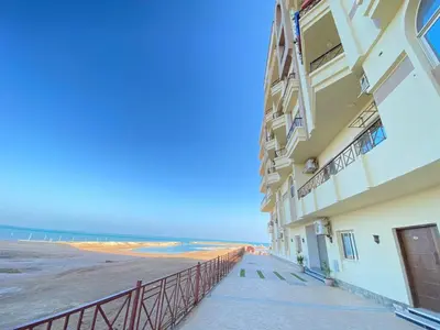 a building on the beach with the ocean in the background at الغردفه كازبلانكا ريزورت in Hurghada