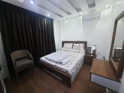 a small bedroom with a bed and a chair at الغردفه كازبلانكا ريزورت in Hurghada