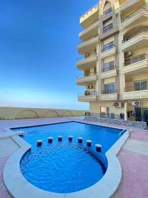 a large swimming pool in front of a building at الغردفه كازبلانكا ريزورت in Hurghada