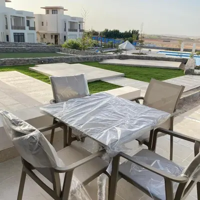 a table and chairs covered in plastic on a patio at Jade 18 A in Hurghada