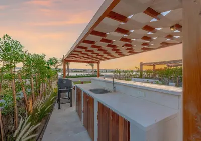 an outdoor kitchen with a counter and a sink at Calm 3BR House in Shedwan Gouna BBQ, Pool & Lagoon in Hurghada