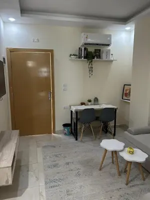 a living room with a table and a couch at شالية فى قرية ميراج باى الغردقة in Hurghada