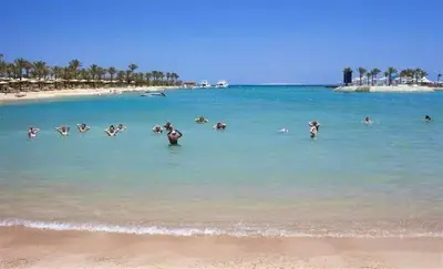 a group of people in the water at a beach at شالية فى قرية ميراج باى الغردقة in Hurghada
