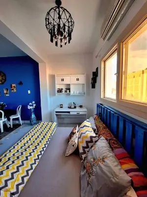 a bedroom with a bed and a chandelier at Orientalna Willa in Hurghada