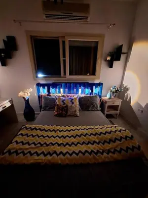 a bedroom with a large bed with blue lights at Orientalna Willa in Hurghada
