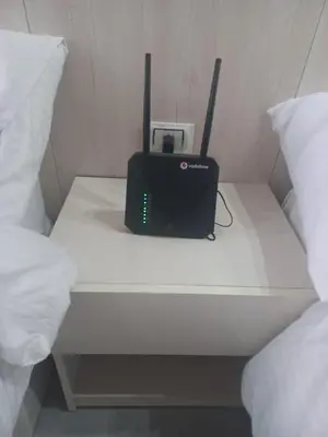 a table with a laptop and a radio on a bed at Scandic Resort Hurghada in Hurghada