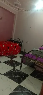 a bedroom with a bed with polka dots on it at شقه للايجار in Luxor