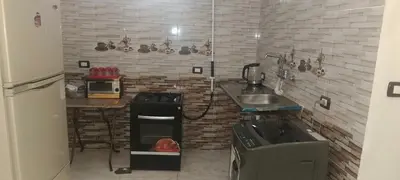 a small kitchen with a sink and a stove at شقه للايجار in Luxor