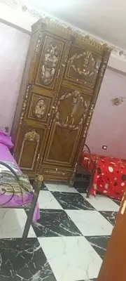 a room with a wall with paintings on it at شقه للايجار in Luxor