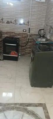a kitchen with a stove and a sink at شقه للايجار in Luxor