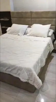 a large bed with white sheets and pillows at فندق ميراج باي in Hurghada
