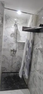 a bathroom with a shower and a sink at فندق ميراج باي in Hurghada