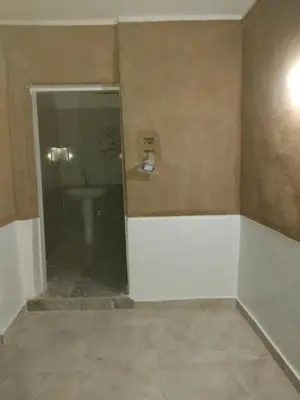 a bathroom with a toilet and a sink in a room at Gateway to the Stars restaurant & camping in Al Aqālitah