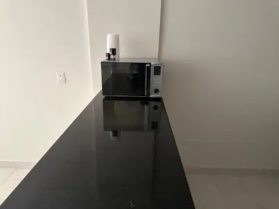 a microwave sitting on top of a wall at luxury apartment in Hurghada